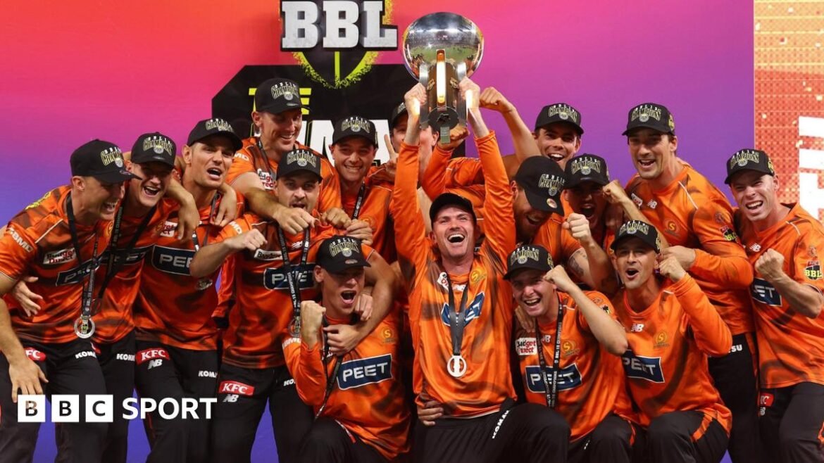 Perth Scorchers players celebrate as they lift the 2025-26 Big Bash League trophy following victory over Sydney Sixers