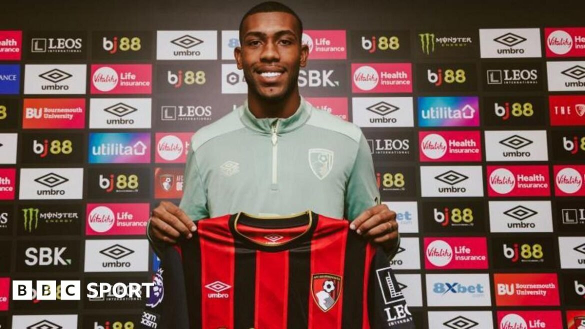 Rayan holding a Bournemouth shirt