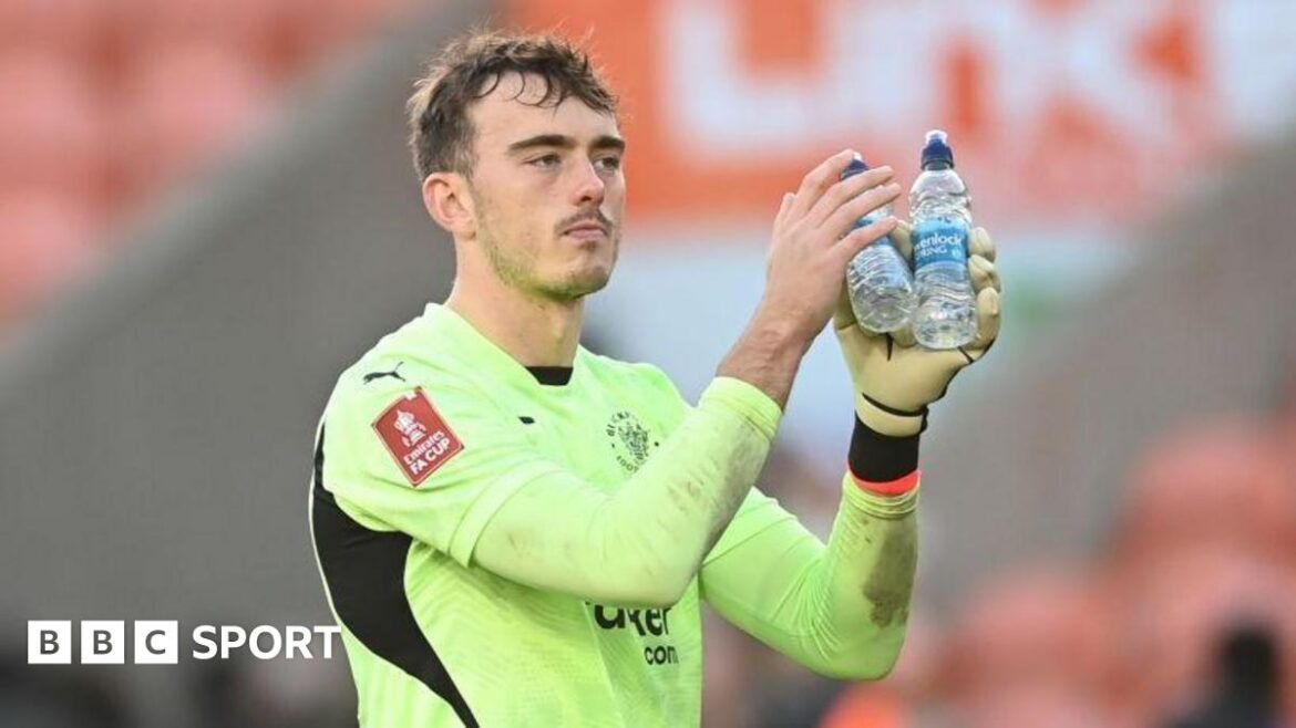 Harry Tyrer applauds fans in a Blackpool kit