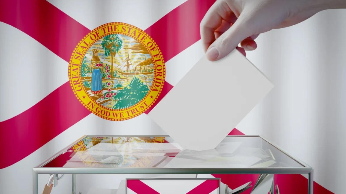Image of a hand dropping a ballot in a voting box in front of a Florida state flag