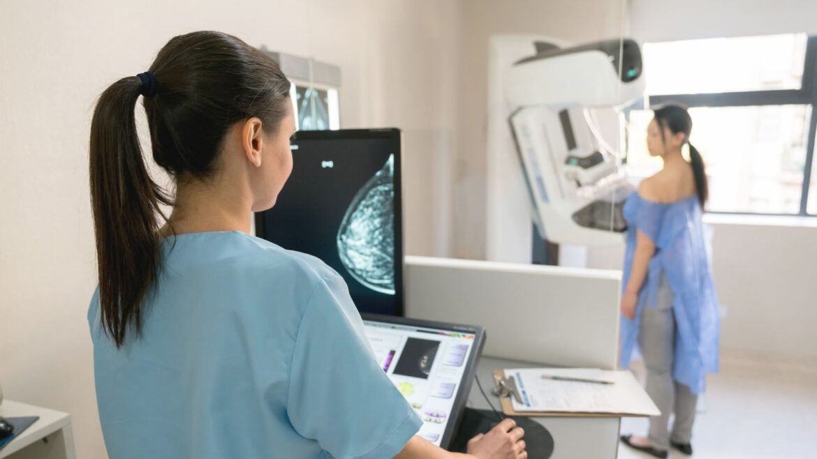 Nurse taking a mammogram exam to an adult patient at the hospital