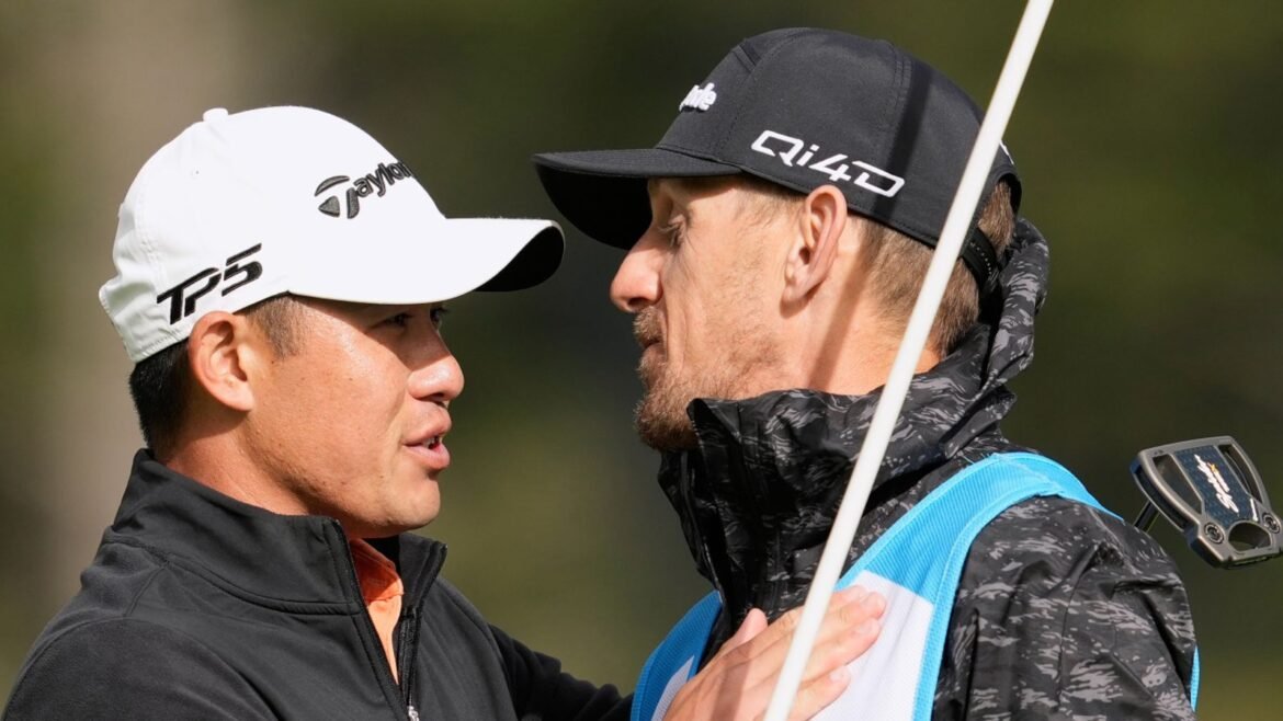 Collin Morikawa, left, celebrates with his caddie, Mark Urbanek, after hitting a birdie putt on the 18th hole at Pebble Beach Golf Links 