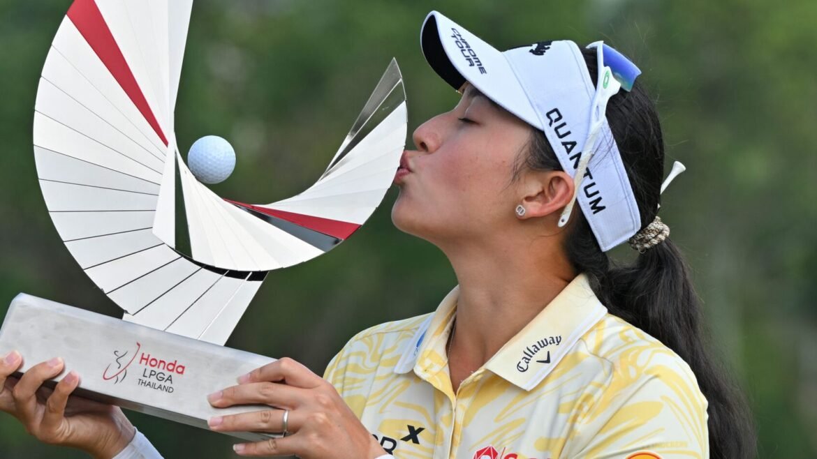 Jeeno Thitikul of Thailand kisses the trophy after winning theLPGA Honda Thailand tournament 