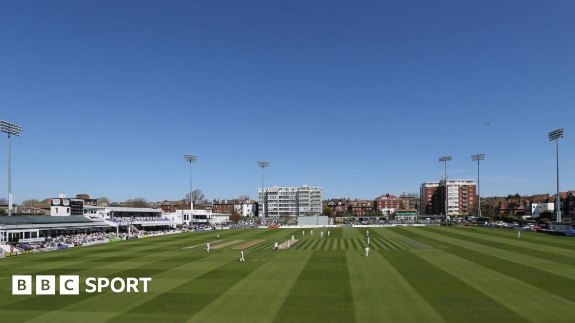 Sussex's Hove cricket ground under blue skies and players out on field in whites