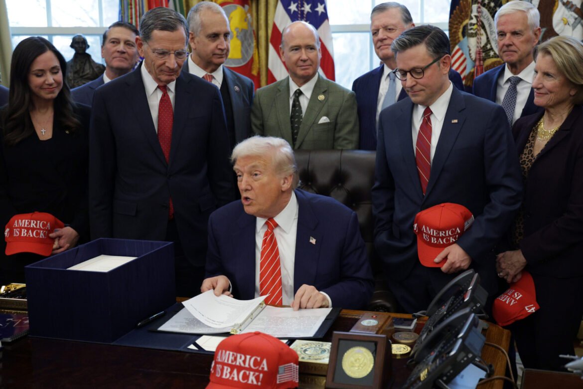 President Donald Trump signs a government funding bill in the Oval Office of the White House on Feb. 3, 2026. (Photo by Alex Wong/Getty Images)