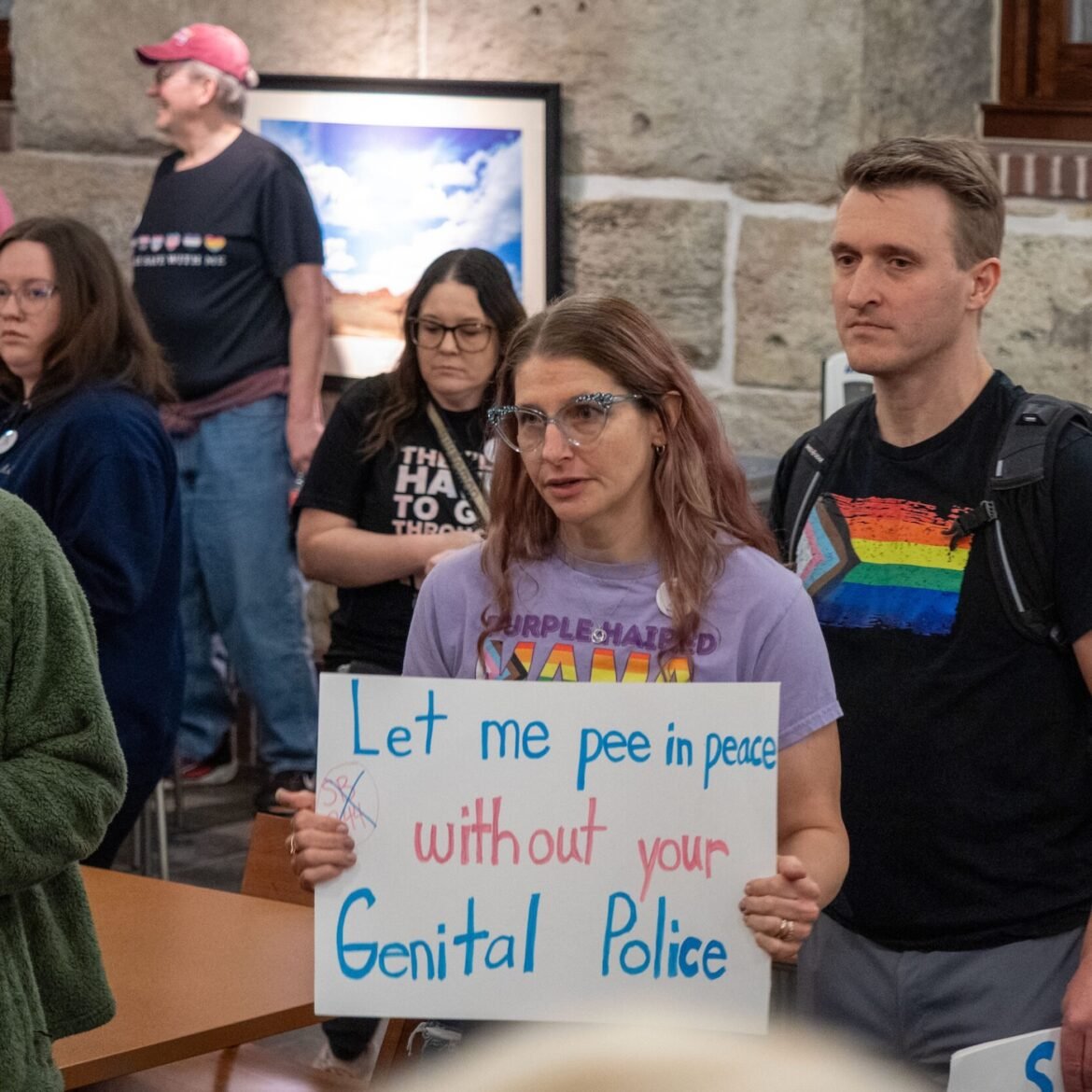 A group of trans activists pose for pictures on Feb. 6, 2026, at the Kansas Statehouse, advocating against a bathroom bill that eventually passed. (Photo by Sherman Smith/Kansas Reflector)