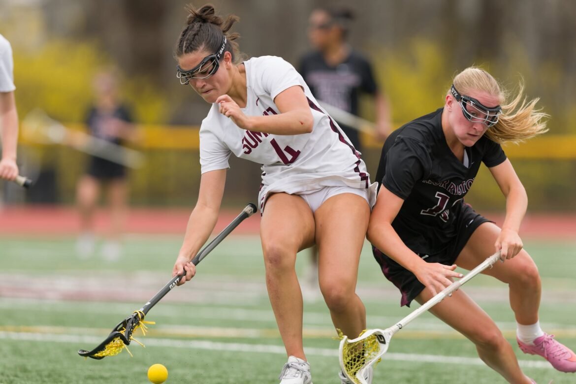 Sara Scalllon of Summit (4) edges out Keira Van Zile of Morristown (16) to make the scoop in Tuesday's high school girls lacrosse showdown in Morristown.  Summit topped the Colonials 9-7.  03/31/2026