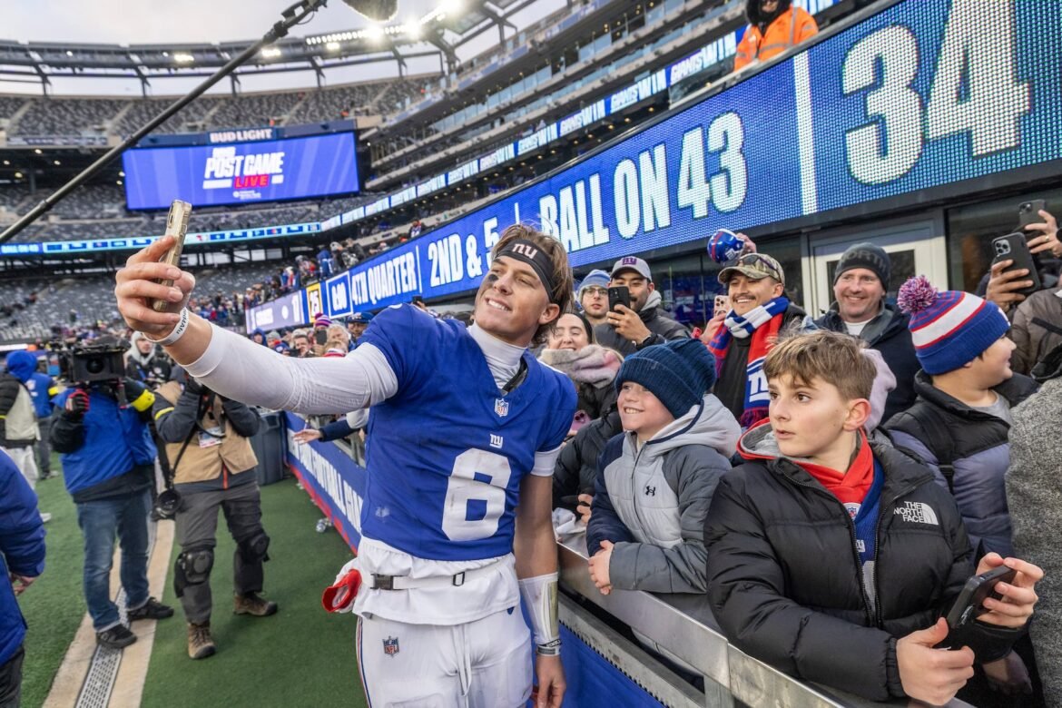 New York Giants rookie quarterback Jaxson Dart (6) with fans after he led the Giants to a 34-17 victory over the Dallas Cowboys in the final game of the season, Sunday, Jan. 4, 2026 in East Rutherford, N.J. 