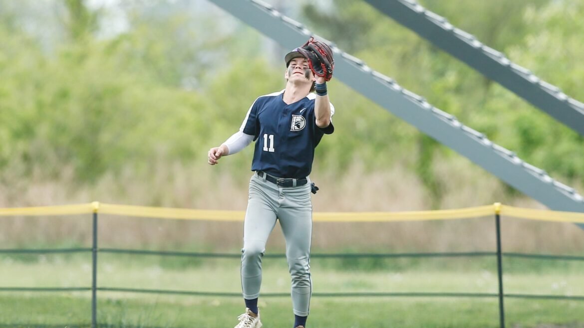 Matthew Kulyk (11) of Doane catches a fly ball for an out.