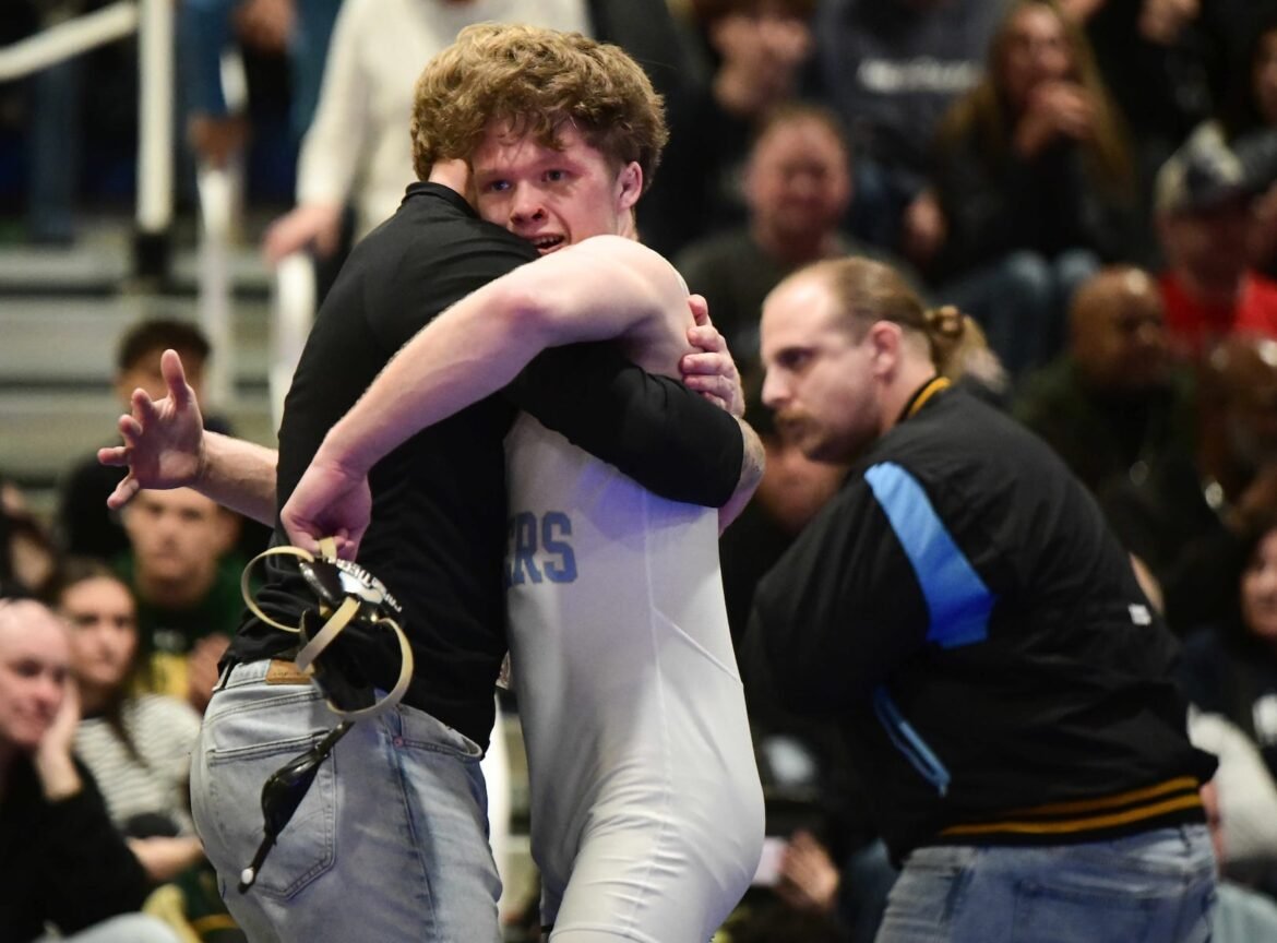 Chase Hansen of Lower Cape May hugs his coach after defeating Amari Vann of Delsea in the 138-pound final of the NJSIAA Region 8 Wrestling Tournament at Williamstown High School, Saturday, March 7, 2026.