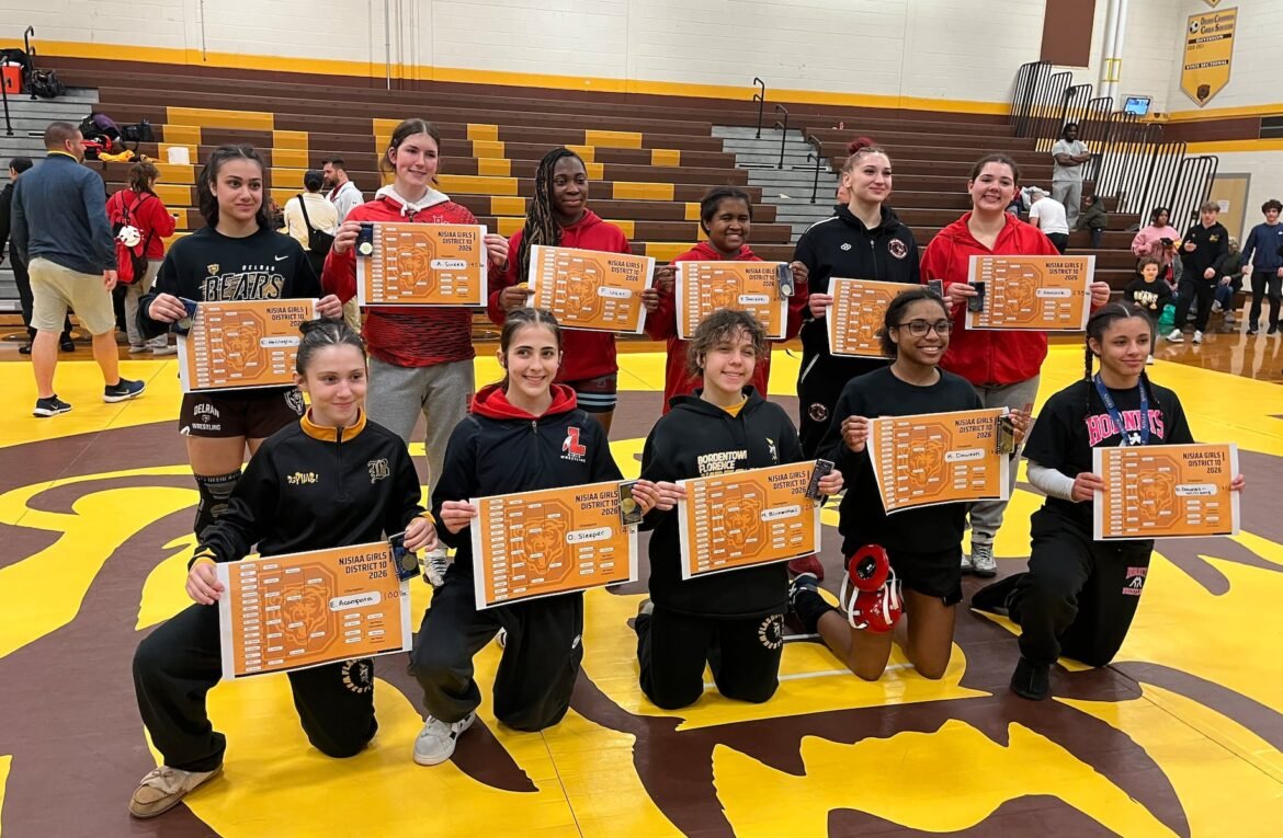 Champions of the inaugural NJSIAA District 10 girls wrestling championships pose for a group photo in the gym at Delran High School on Sunday, March 1, 2026.