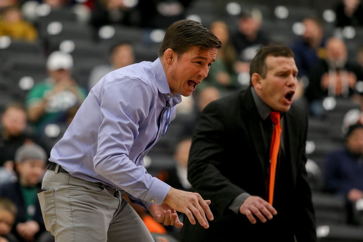 Princeton head coach Chris Ayres (blue shirt) and assistant Sean Gray encourage their team during the wrestling match between Princeton and Rider at Jadwin Gymnasium in Princeton on Saturday, January 21, 2023.
