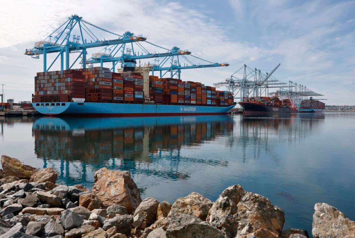 Shipping cranes stand above container ships loaded with shipping containers at the Port of Los Angeles on Feb. 20, 2026 in Los Angeles, California. The U.S. Supreme Court has ruled that President Donald Trump’s sweeping emergency tariffs on most U.S. trading partners were illegal. (Photo by Mario Tama/Getty Images)