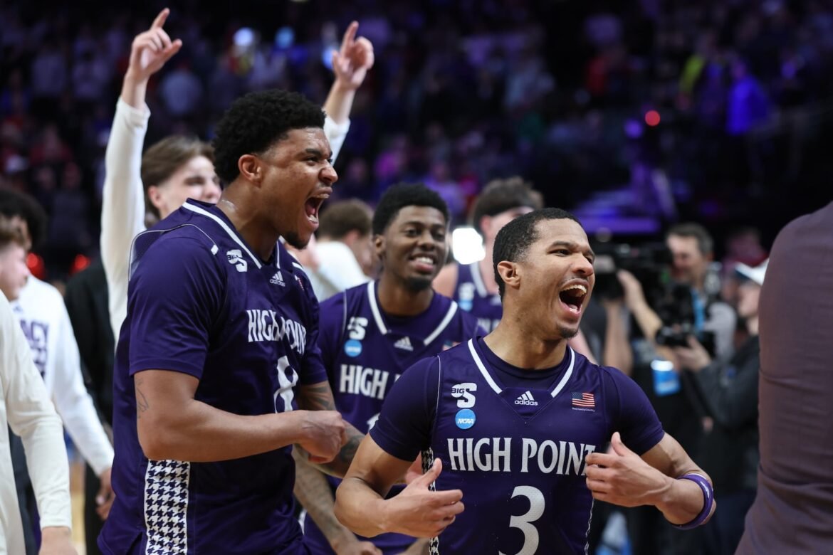 High Point guard Rob Martin (3) celebrates with forward Owen Aquino (8) after the first round of the NCAA college basketball tournament against Wisconsin, Thursday, March 19, 2026, in Portland, Ore. (AP Photo/Craig Mitchelldyer)