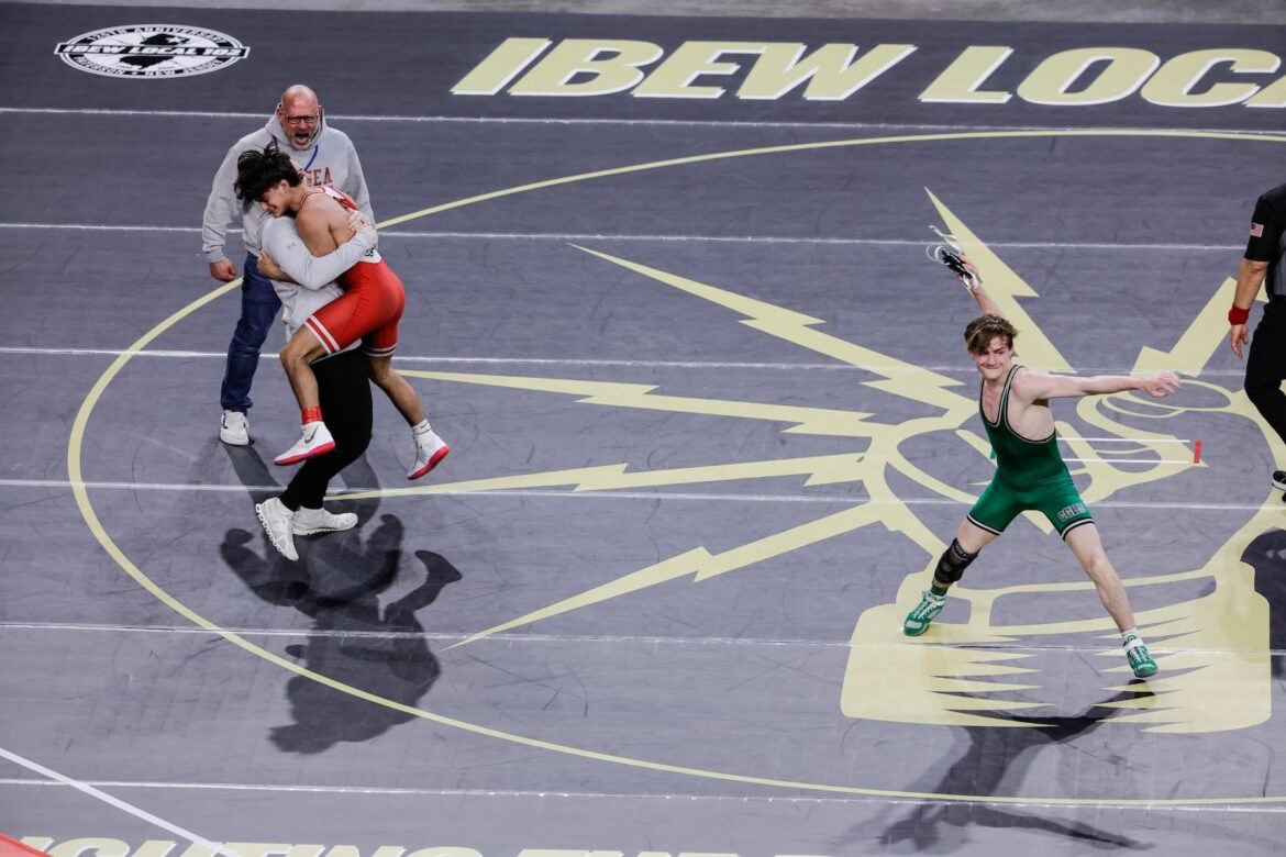 Greyson Pettit of Delsea celebrates with his coaches after hs defeated Sammy Spaulding of Camden Catholic, who launches his headhear in frustration at 132 pounds during the semifinals of the NJSIAA State Wrestling Championships at Boardwalk Hall in Atlantic City, NJ on 3/13/26.