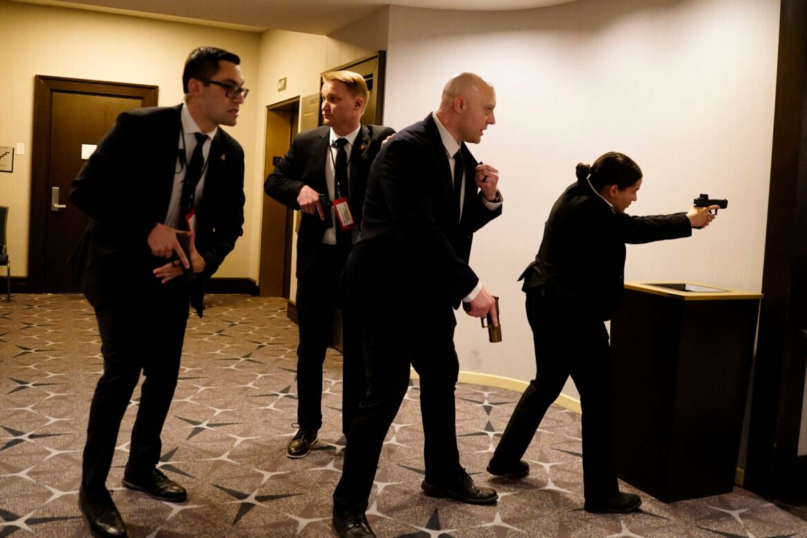 Federal agents draw their guns out after an incident at the annual White House Correspondents Association Dinner April 25, 2026. According to reports, President Donald Trump, along with other government officials, were evacuated from the Washington Hilton after what sounded like gun fire. (Photo by Nathan Howard/Getty Images)