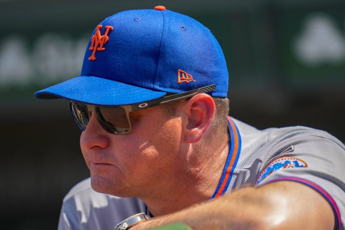 New York Mets manager Carlos Mendoza stands stands in the dugout during the first inning of a baseball game against the Chicago Cubs, Friday, April 17, 2026, in Chicago. (AP Photo/Erin Hooley)