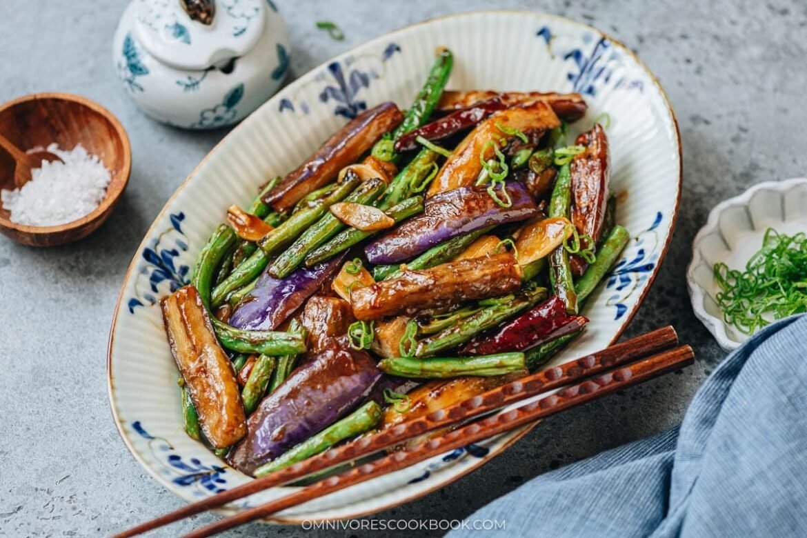 Plated eggplant and green beans with glossy savory sauce and scallions