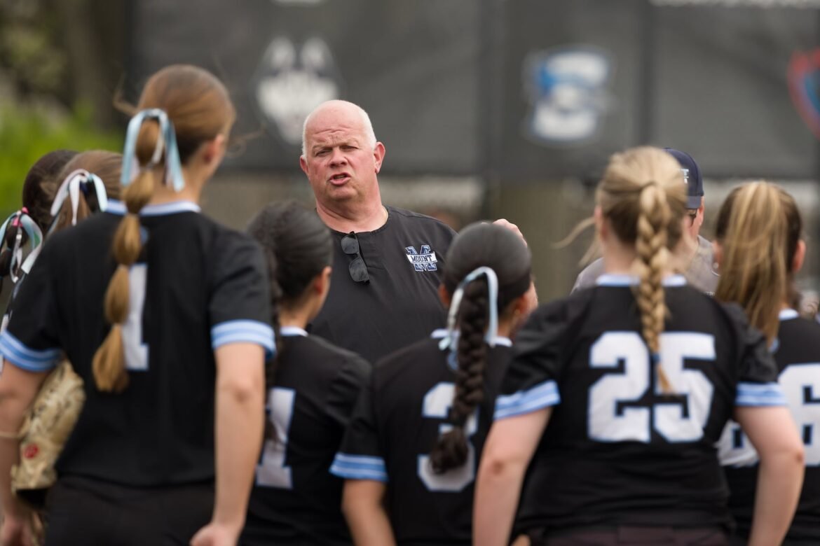 Mount St. Dominic head coach Rob Stern dialogs with his team between innings of the Private vs. Public Challenge high school softball matchup against Colts Neck on Saturday in South Orange.  The Cougars bit the Lions, 6-5.  04/19/2025