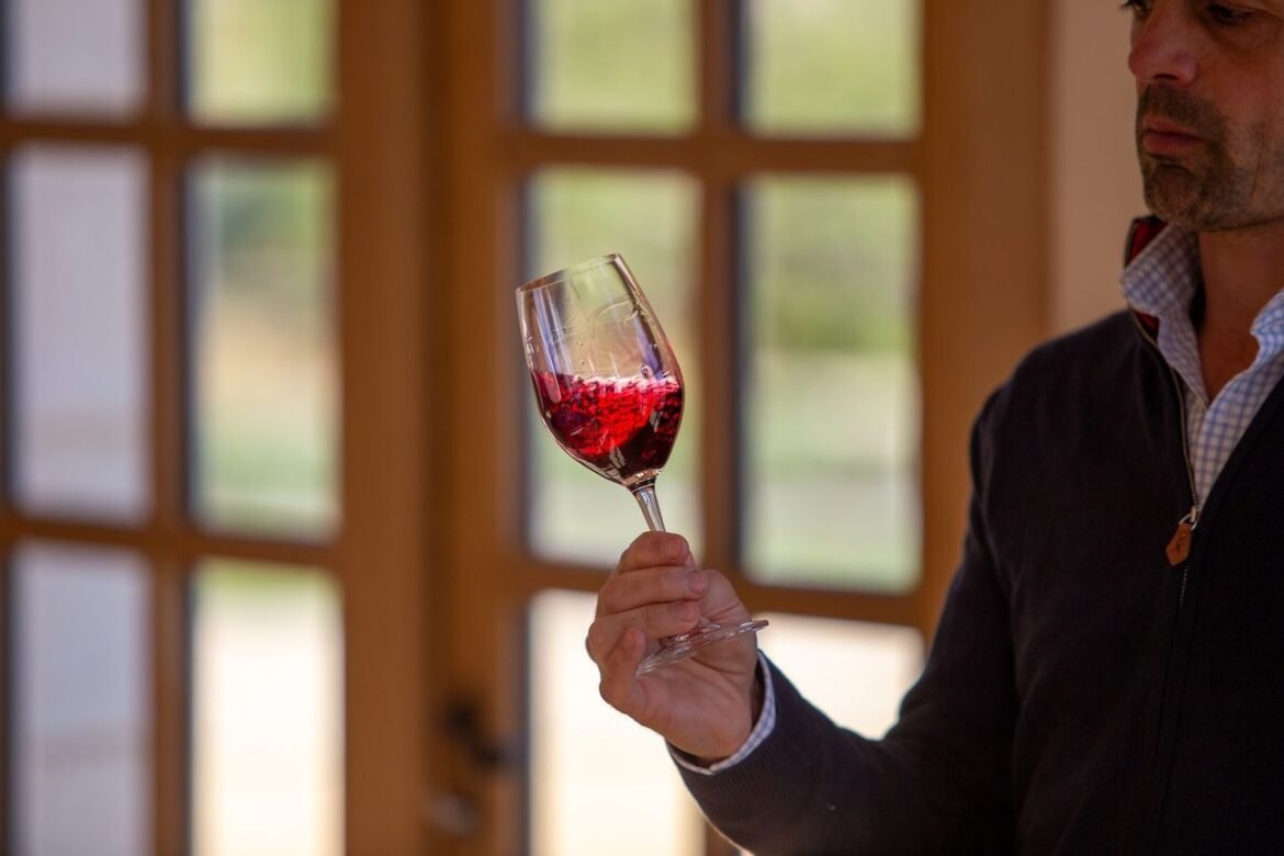 winemaker swirling red wine in glass