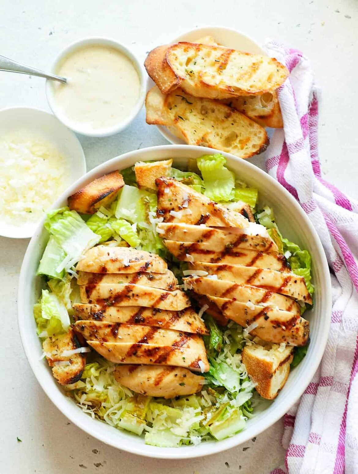 Serving up a plate of refreshing grilled chicken Caesar salad dressing for a healthy lunch.