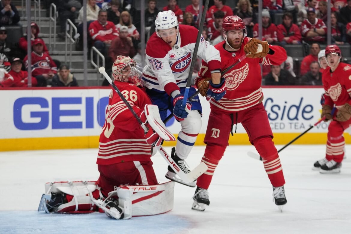 Montreal Canadiens right wing Zachary Bolduc jumps past Detroit Red Wings goaltender John Gibson as J.T. Compher (37) looks on in the third period Thursday. (AP Photo/Paul Sancya)
