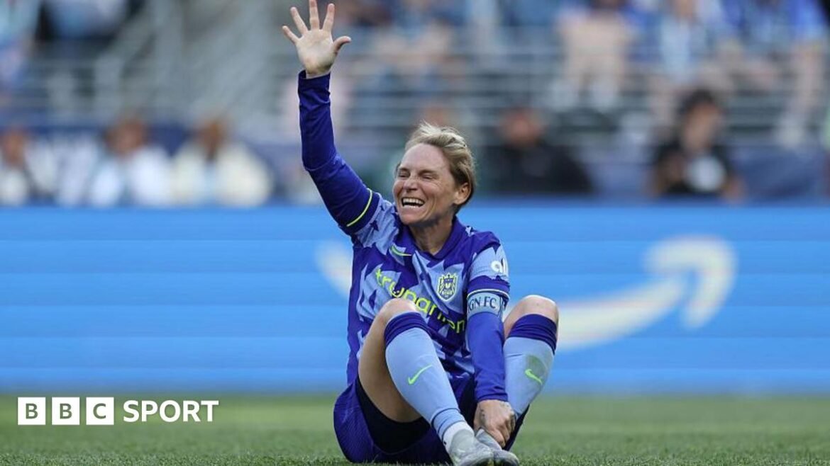Jess Fishlock clutches her ankle on the pitch 