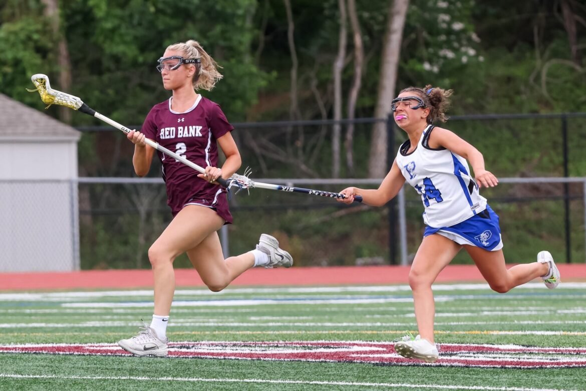 Chloe Keating (2) of Red Bank Regional moves the ball past Leah Bornstein (14) of Princeton during the North Jersey, Group 3 first round girls lacrosse game at Red Bank Regional in Little Silver, NJ on Thursday, May 29, 2025.
