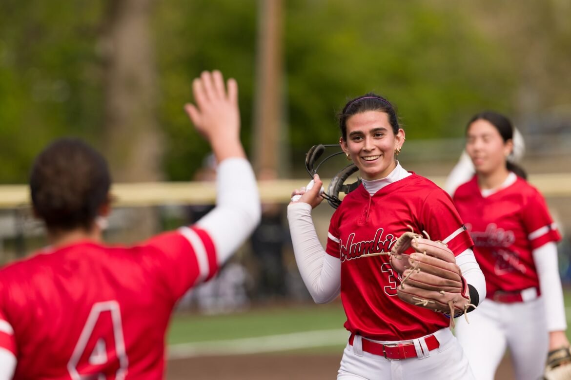 Columbia hurler Claire Shupe rips off her mask after pitching out of trouble to close out Sunday's Black and Gold high school softball invitational matchup against DePaul in Cedar Grove. The Cougars held off a late Spartan threat to win 2-0.  04/26/2026