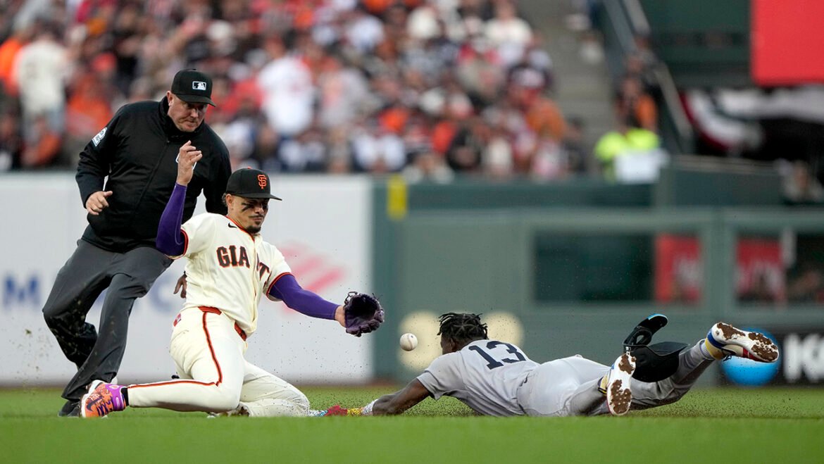 Jazz Chisholm Jr. #13 of the New York Yankees safely steals second base against Willy Adames #2 of the San Francisco Giants during the fifth inning on Opening Day at Oracle Park on March 25, 2026 in San Francisco, California.