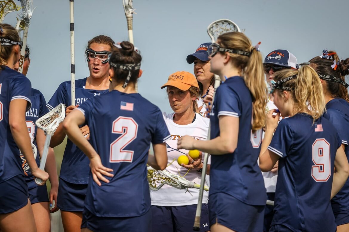 Trinity Hall girls lacrosse head coach Dana Lenneper (center) speaks to her team during girls lacrosse against Manasquan, Thursday, April 16, 2026, in Oceanport, N.J. 