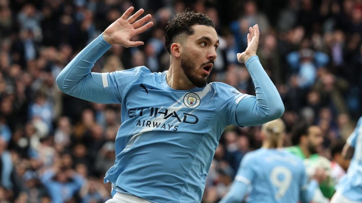 Rayan Cherki reacts after seeing his goal-bound shot deflect onto the post