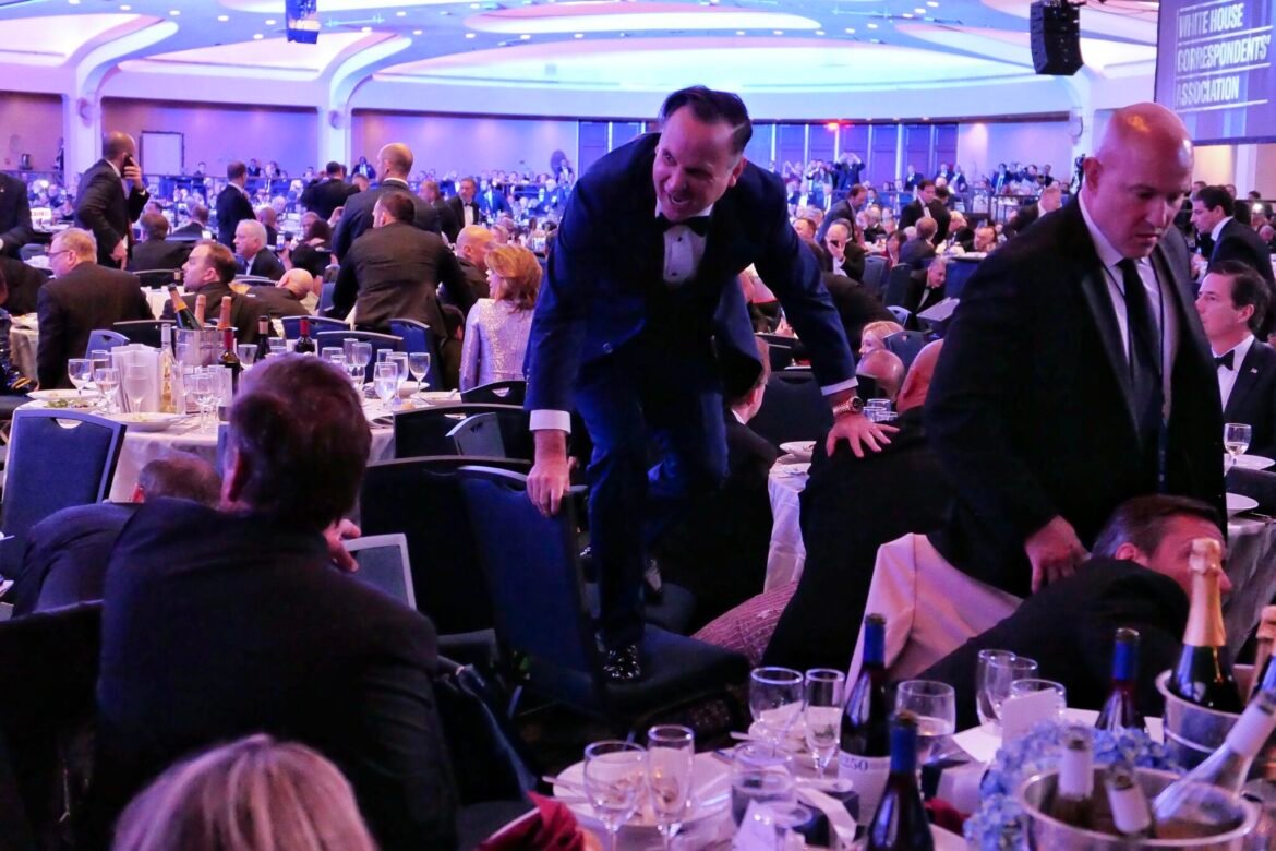 White House Deputy Chief of Staff Dan Scavino jumps over a chair after gunfire was heard and officials evacuated at the White House Correspondents' Association Dinner April 25, 2026 in Washington, DC. (Photo by Chip Somodevilla/Getty Images)