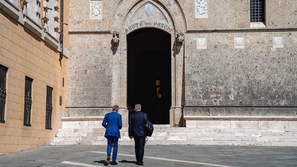 Visitors outside the Banca Monte dei Paschi di Siena SpA bank headquarters in Siena, Italy.