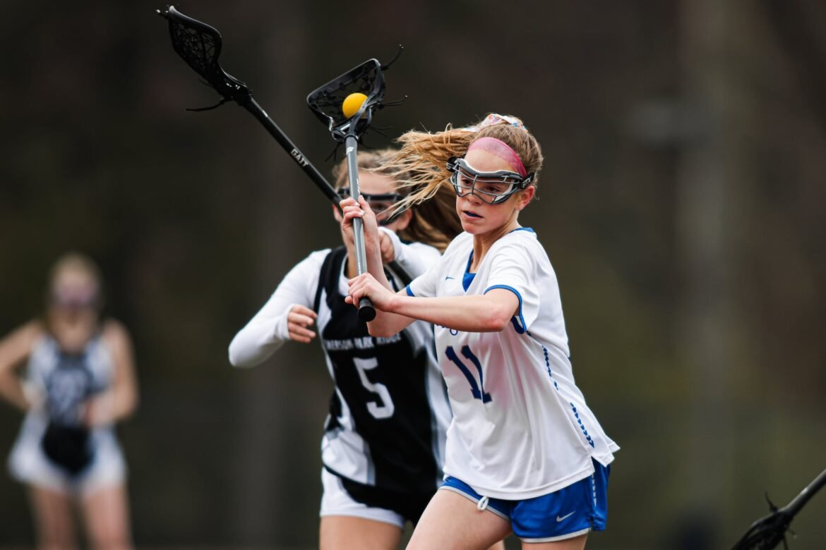 Jane Tenaglia (11) of Holy Angels takes a shot while against Lia Francica (5) of Emerson Boro during the girls lacrosse game between Holy Angels and Emerson Boro at Academy of Holy Angels in Demarest, NJ on Thursday, April 11, 2024.