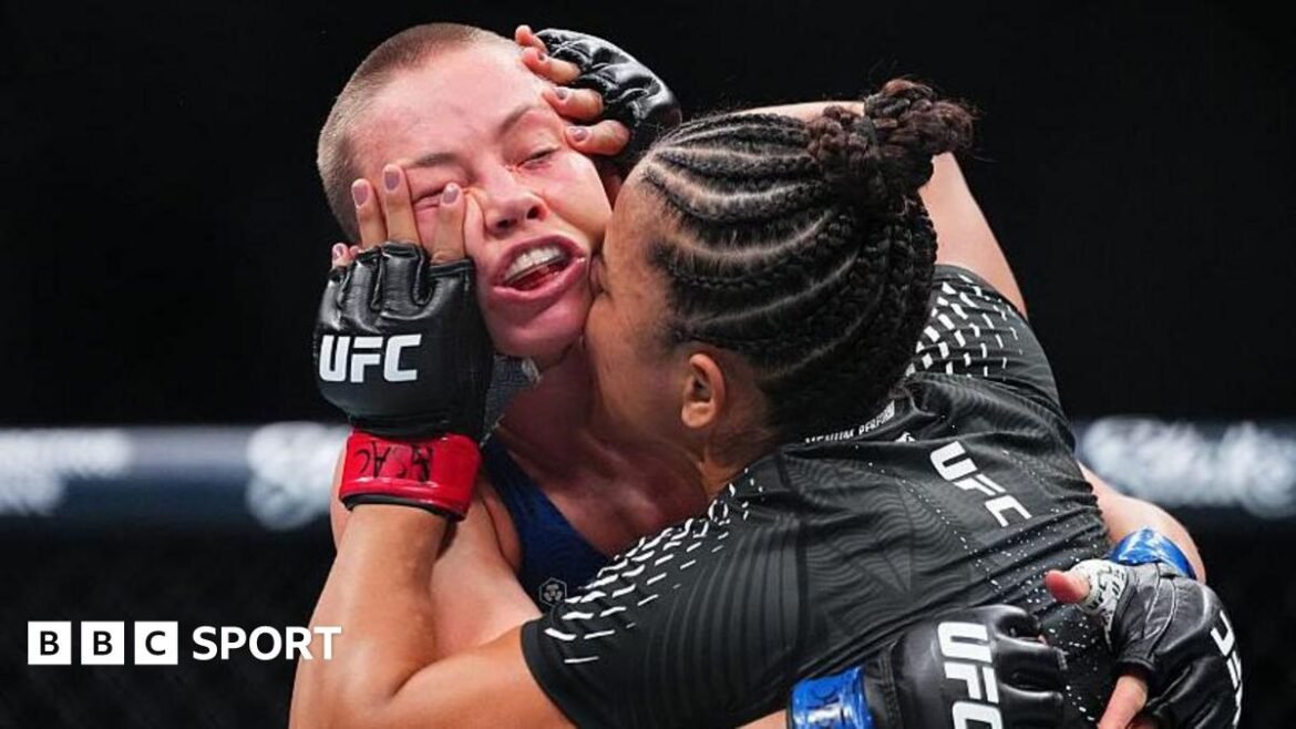 Natalia Silva holds her hands on the face of Rose Namajunas