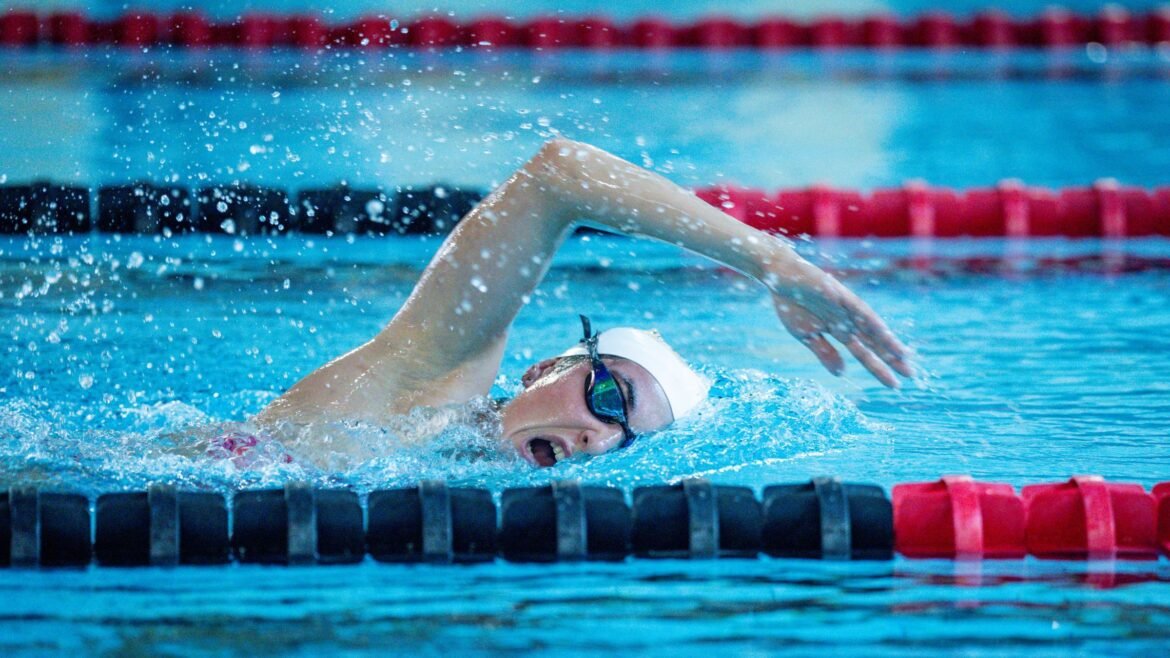 A triathlete swims in a pool after having worked on mobility issues to improve swim breathing.