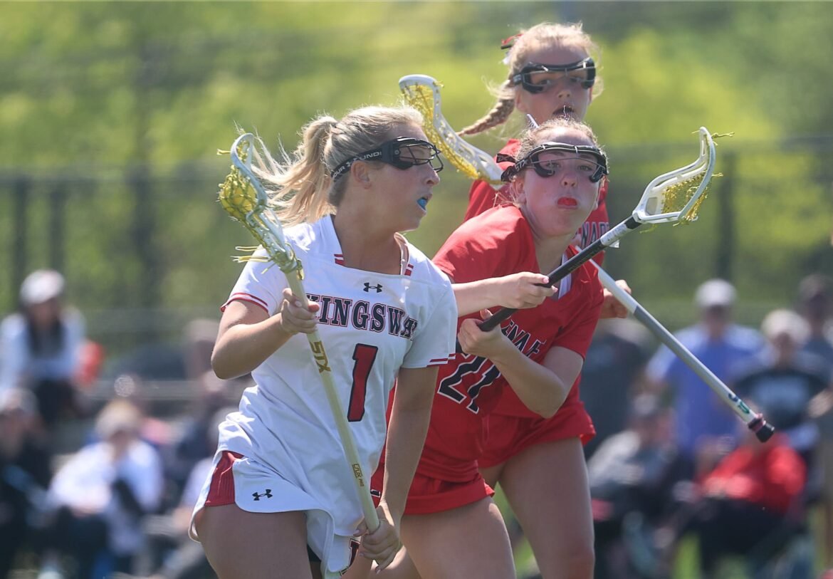 Phoebe O'Rourke (1) of Kingsway sprints around the defense of Addie Haskins (22) and Olivia Buciorelli (12) of Lenape during the fourth quarter of the Kingsway vs. Lenape girls lacrosse game at Lenape High School in Medford, NJ, Saturday, April 18, 2026.