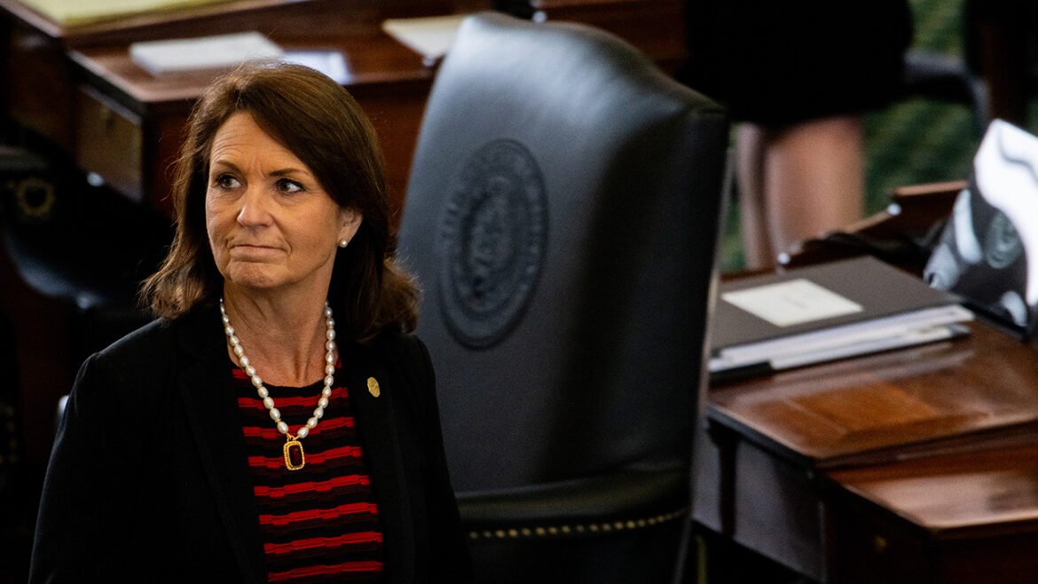 Angela Paxton looks on