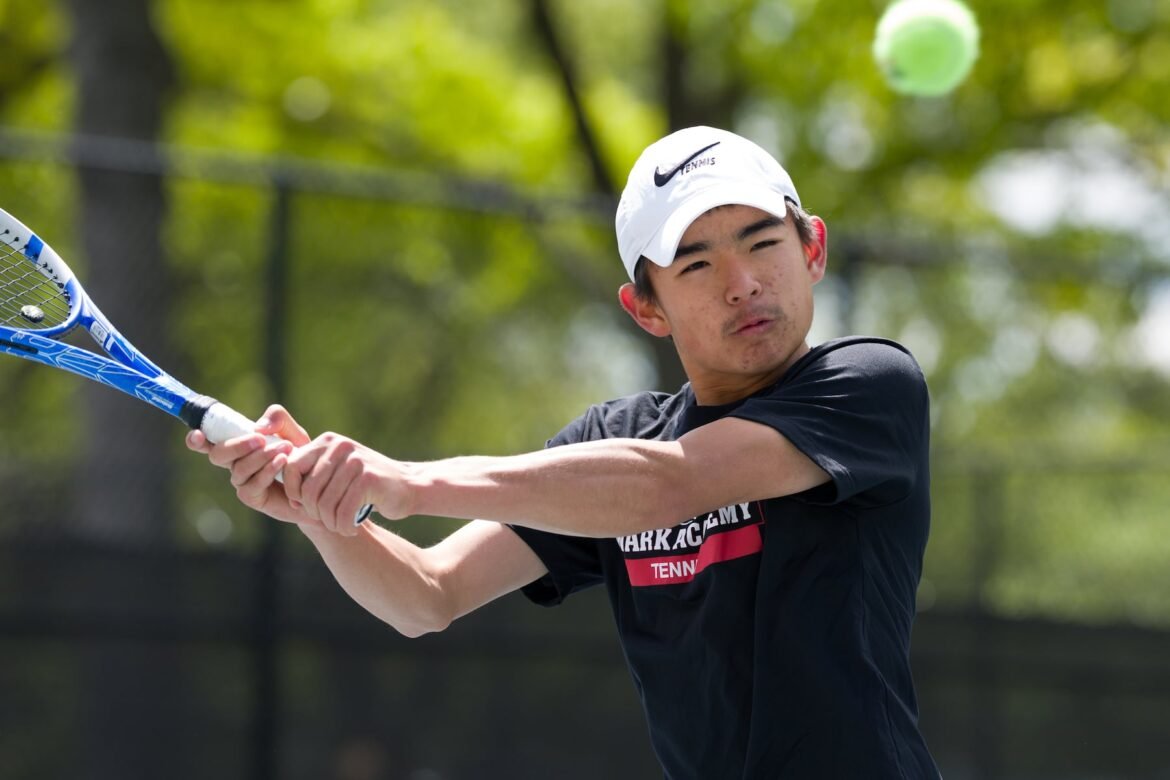 Daniel Zhou of Newark Academy reaches to volley against Millburn in 3rd singles of Sunday's Essex County high school boys tennis tournament final in Newark. The Minutemen marched to a 5-0 victory over the Millers. 05/03/2026