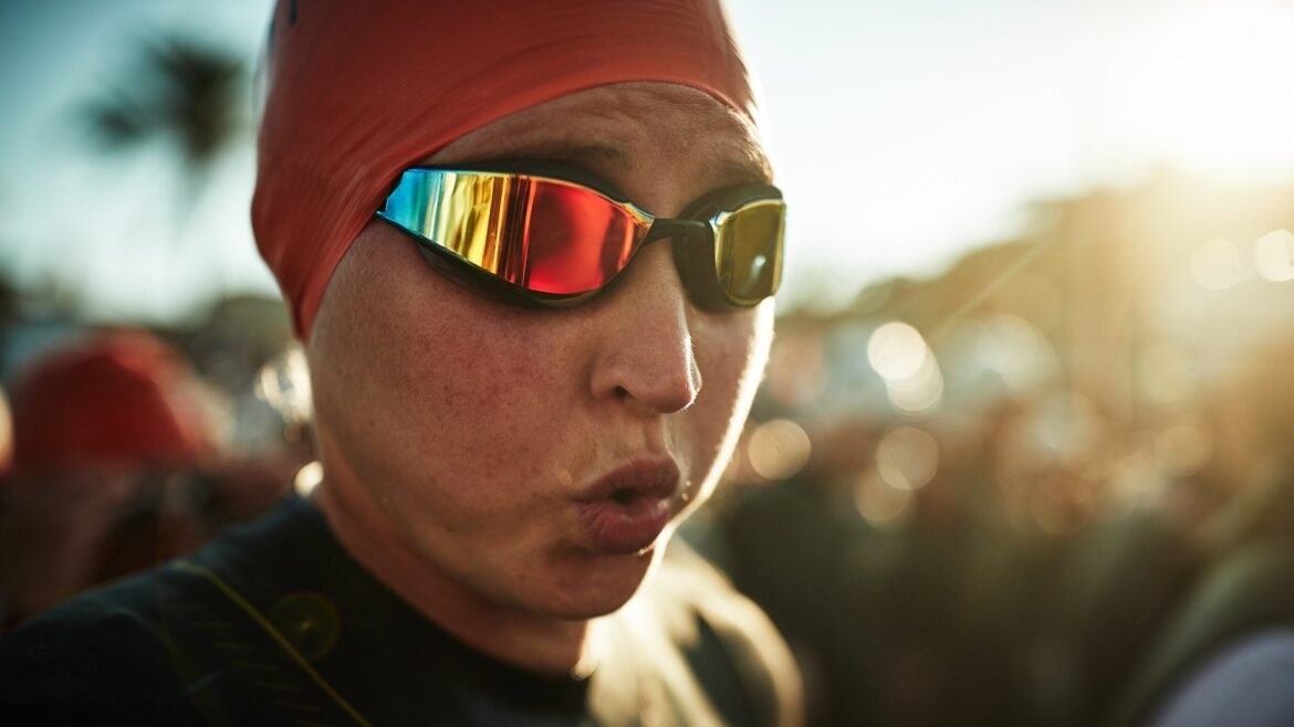 A triathlete breathes out before the start of the swim.