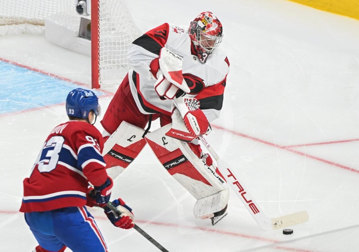 Carolina Hurricanes goaltender Frederik Andersen (31) clears the puck as Montreal Canadiens' Ivan Demidov (93) moves in during third period of Game 4 of the NHL Eastern Conference final Stanley Cup playoff series game in Montreal on Wednesday, May 27, 2026. (Graham Hughes/The Canadian Press via AP)
