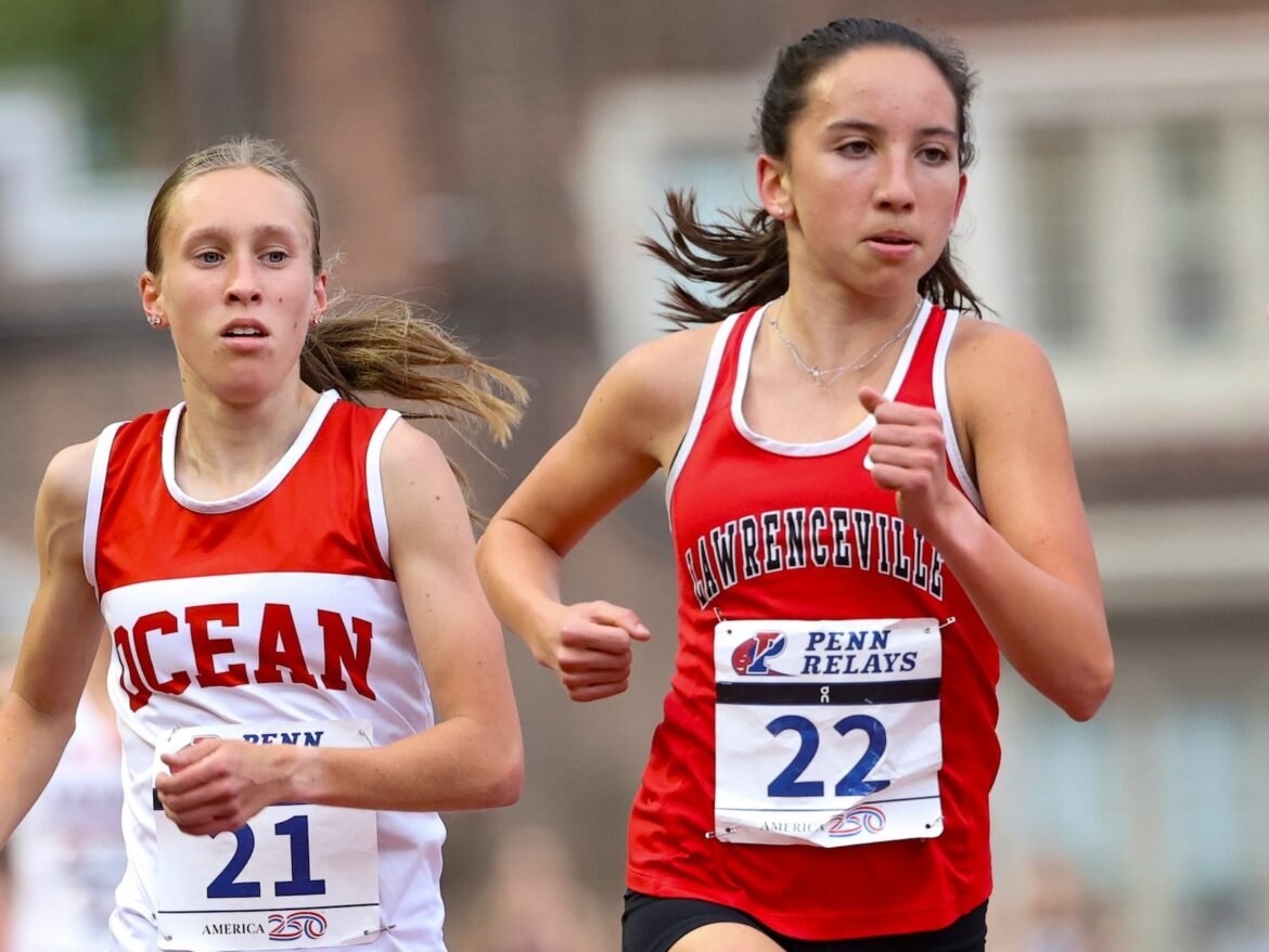 Blair Bartlett of Lawrenceville (right) Leah Starkey of Ocean Township are close on the final lap of the High School Girls' 3000m Championship at the 130th Penn Relays Friday, April 24, 2026, in Philadelphia. Bartlett won with a time of 9:04.92 that broke the meet record she set last year. 