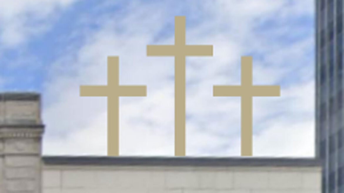 Three golden crosses stand on top of a building.