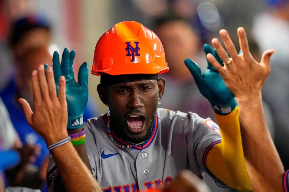 New York Mets' Ronny Mauricio is congratulated by teammates in the dugout after hitting a solo home run during the seventh inning of a baseball game against the Los Angeles Angels, Friday, May 1, 2026, in Anaheim, Calif. (AP Photo/Mark J. Terrill)