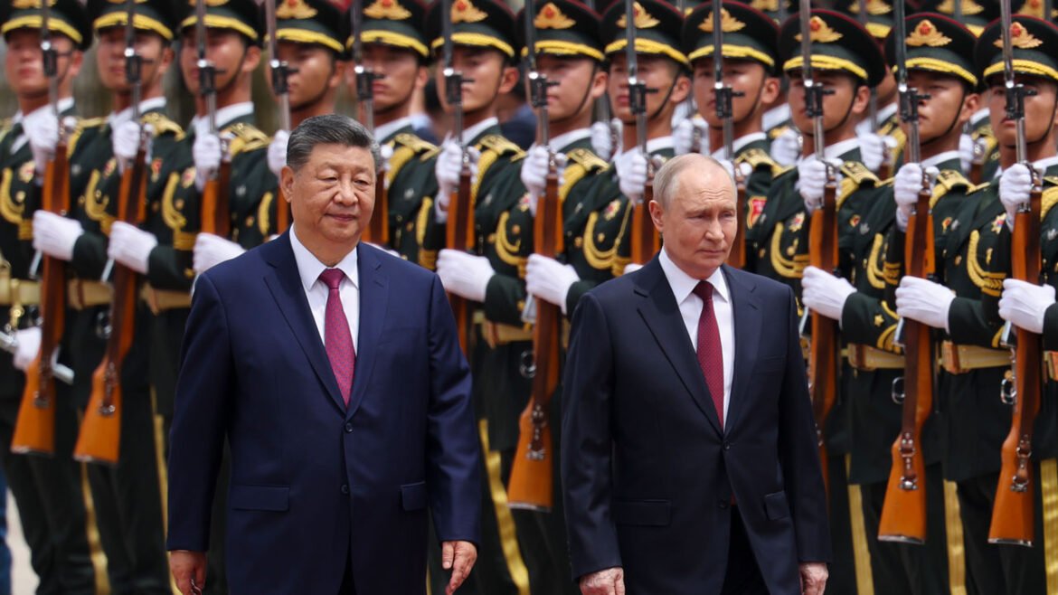 Xi Jinping and Vladimir Putin walk along a row of Chinese soldiers.