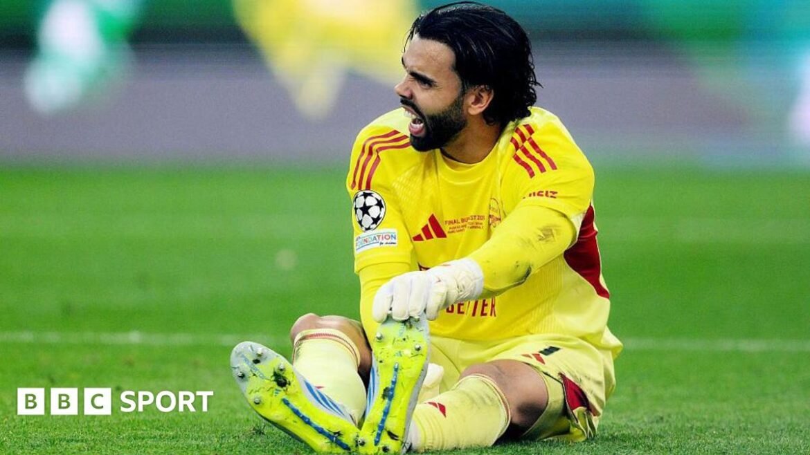 David Raya of Arsenal goes down holding his foot during the 2026 UEFA Champions League final against Paris St-Germain