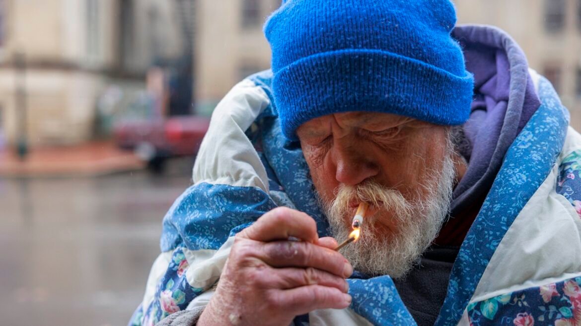 A man lighting a cigarette