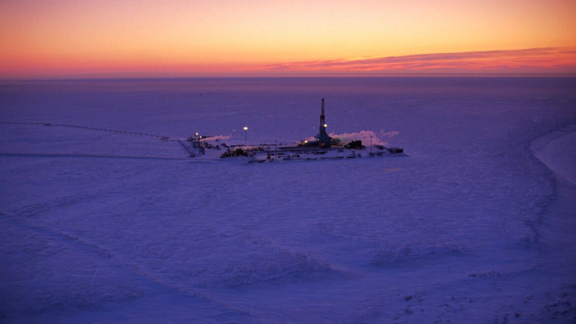 An oil well at Alaska's Prudhoe Bay as the sun sets.