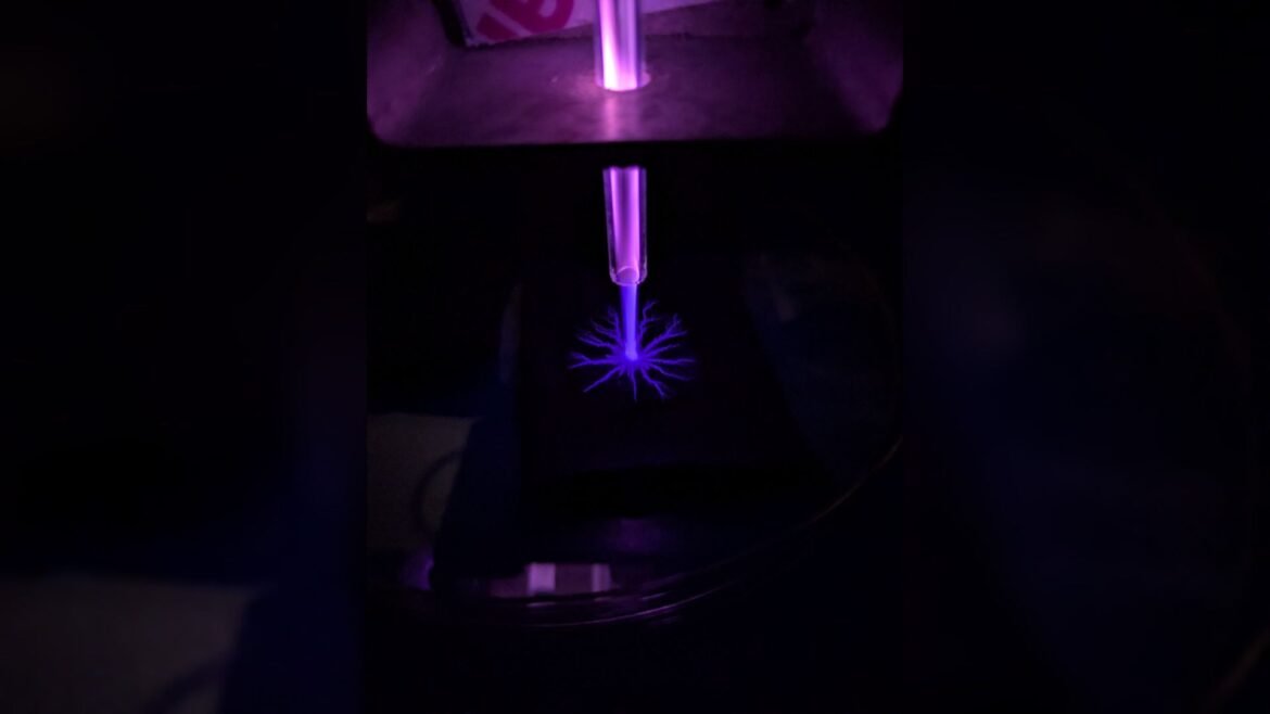 A close up of a blue laser in a dark room.